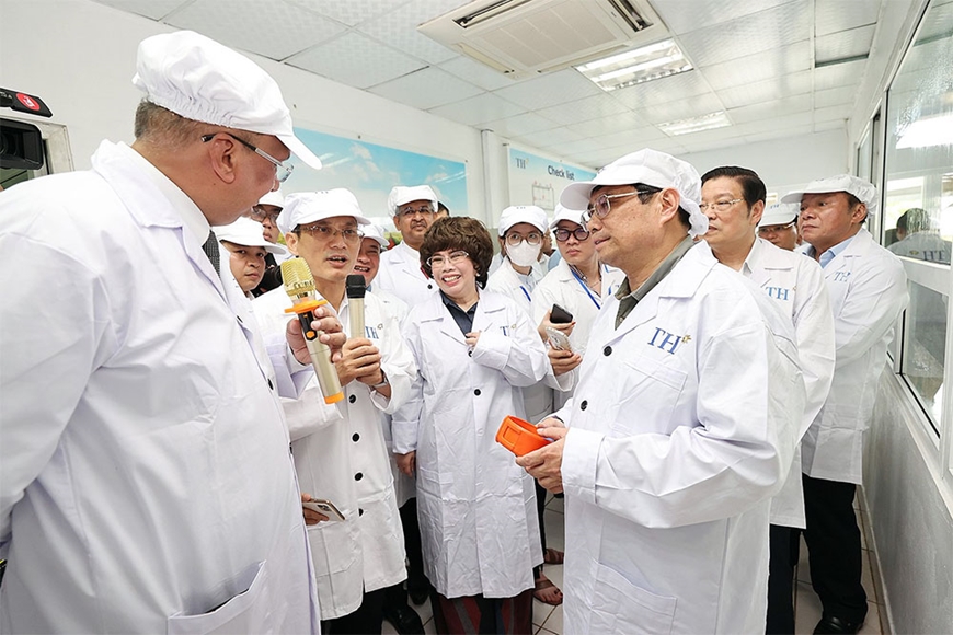 Thủ tướng Chính phủ Phạm Minh Chính nghe giới thiệu về công nghệ chăn nuôi bò sữa tập trung của Tập đoàn TH